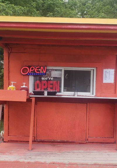 Red food stand with OPEN sign at Masonville Corner Store